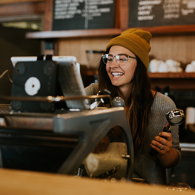 Woman Processing Checkout Coffee Shop